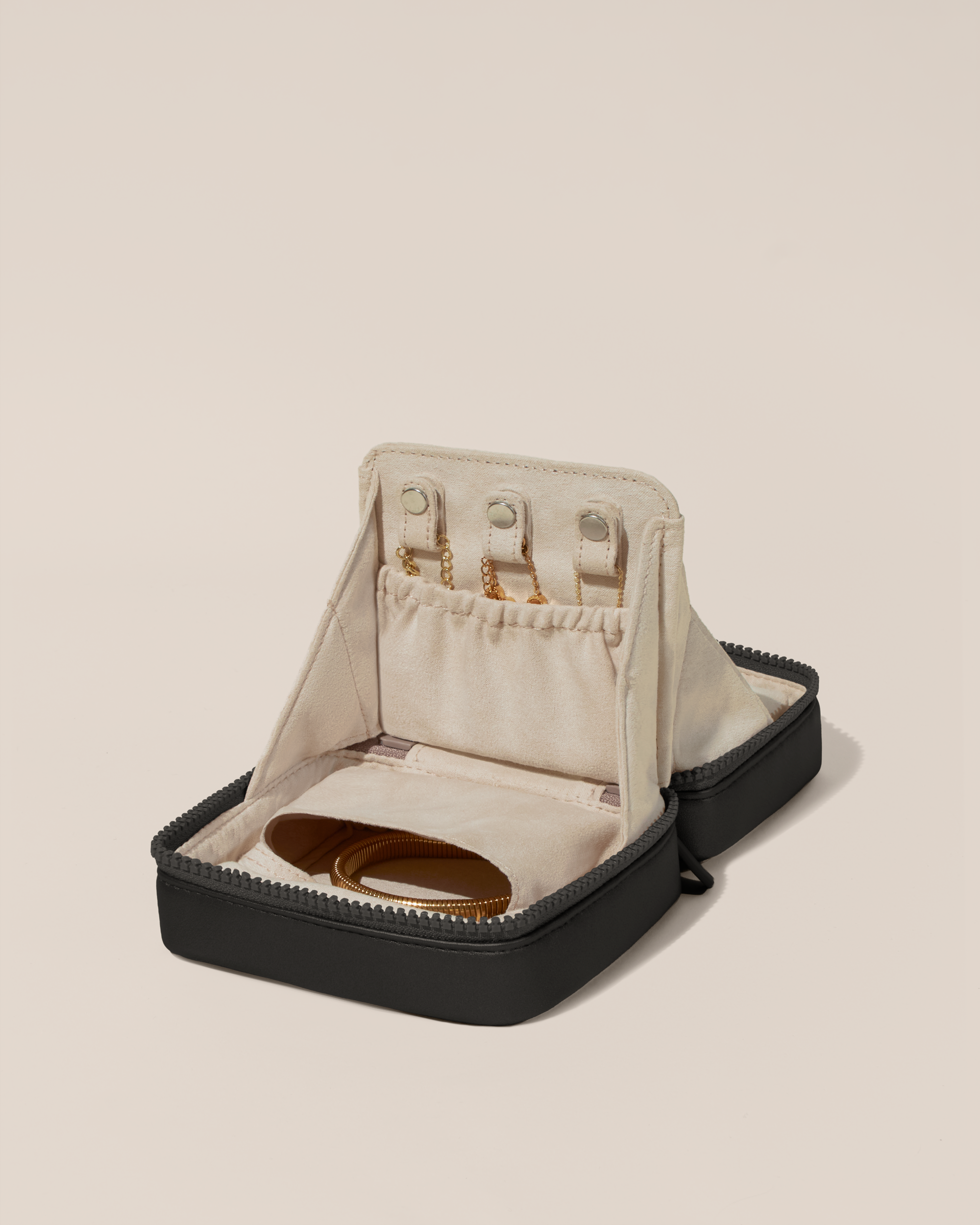 Open Afform Small Onyx (black) Vault, shown open and packed with necklaces in dedicated necklace pouches with snaps to keep them in place. Bracelets are packed in a zipper pocket.