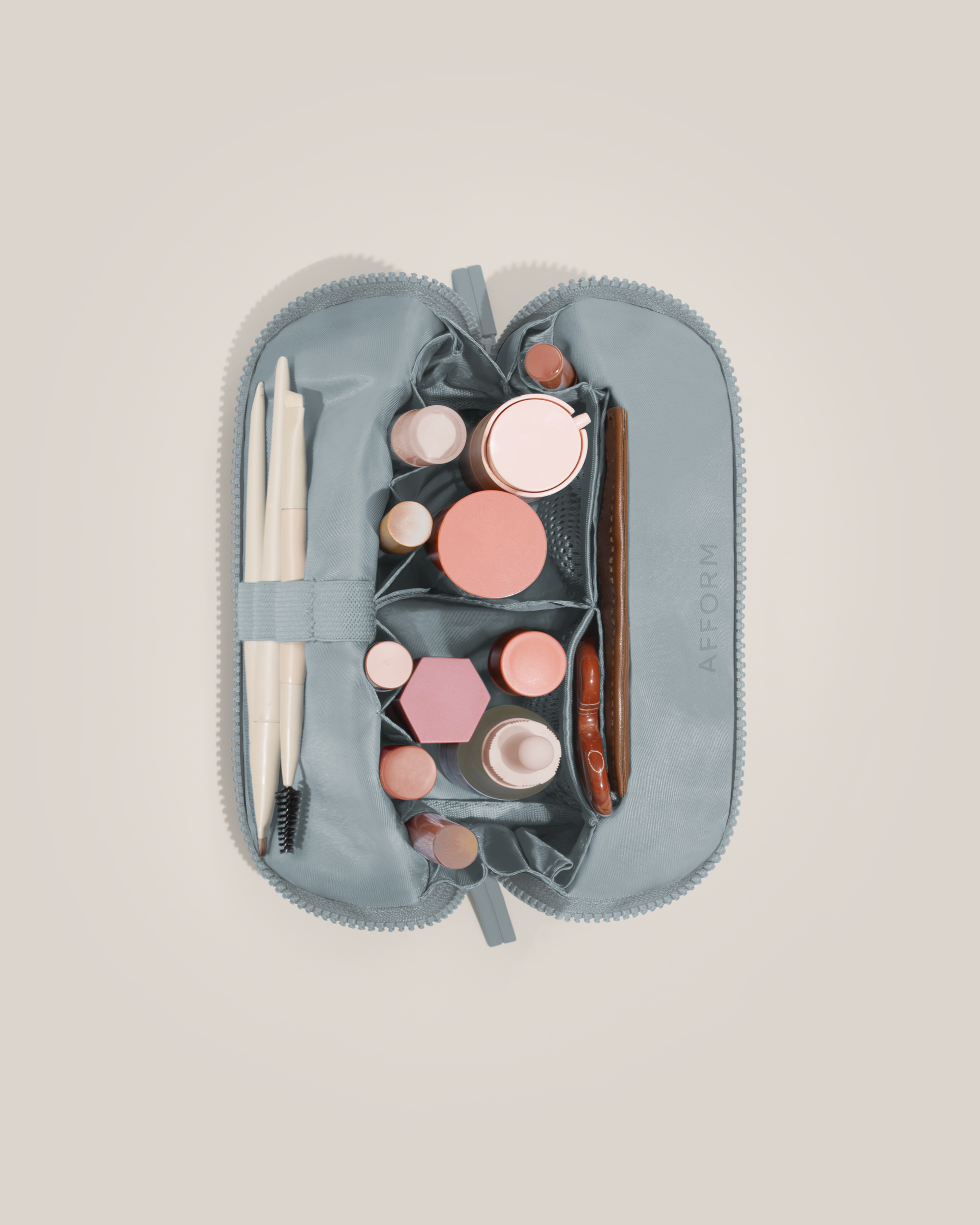 Interior view of Afform Small Slate (blue) Traveller makeup bag showing empty pockets, pouches, and elastic holders