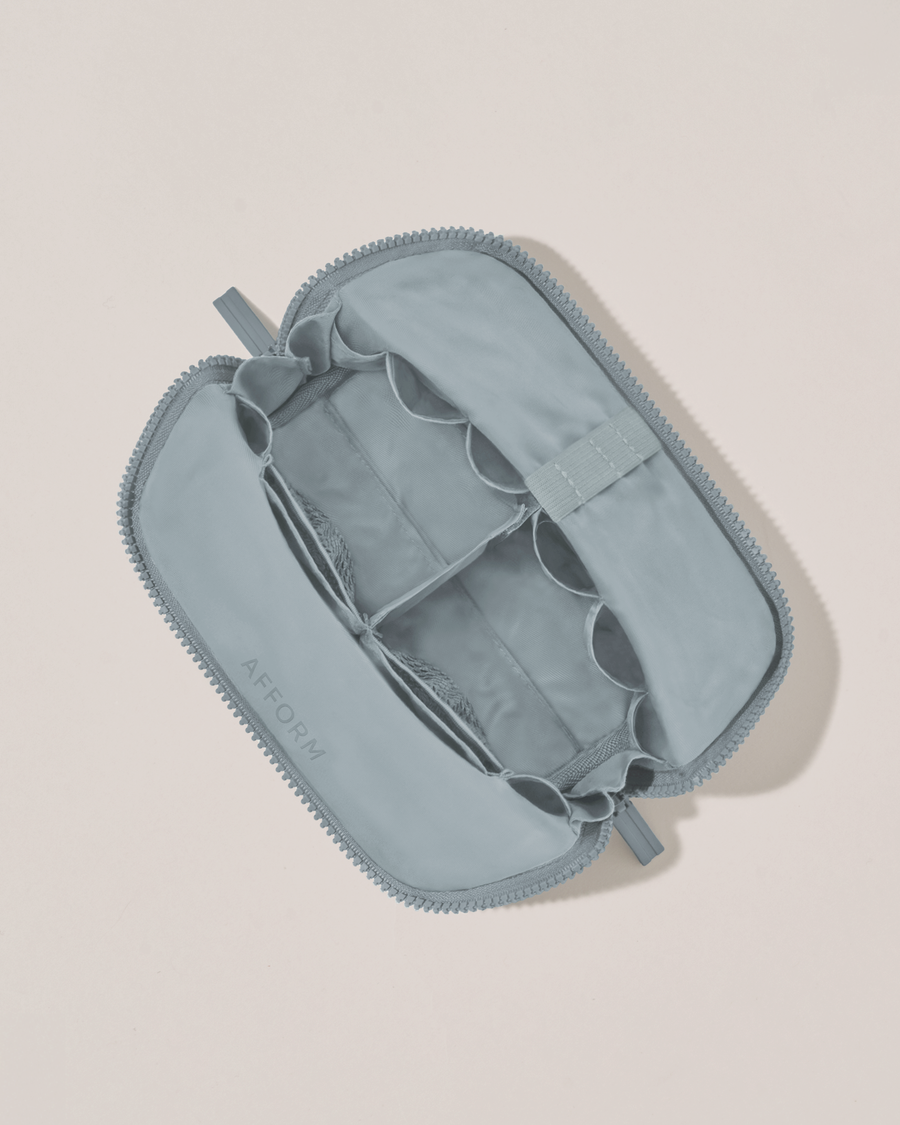Interior view of Afform Small Slate (blue) Traveller makeup bag showing empty pockets, pouches, and elastic holders