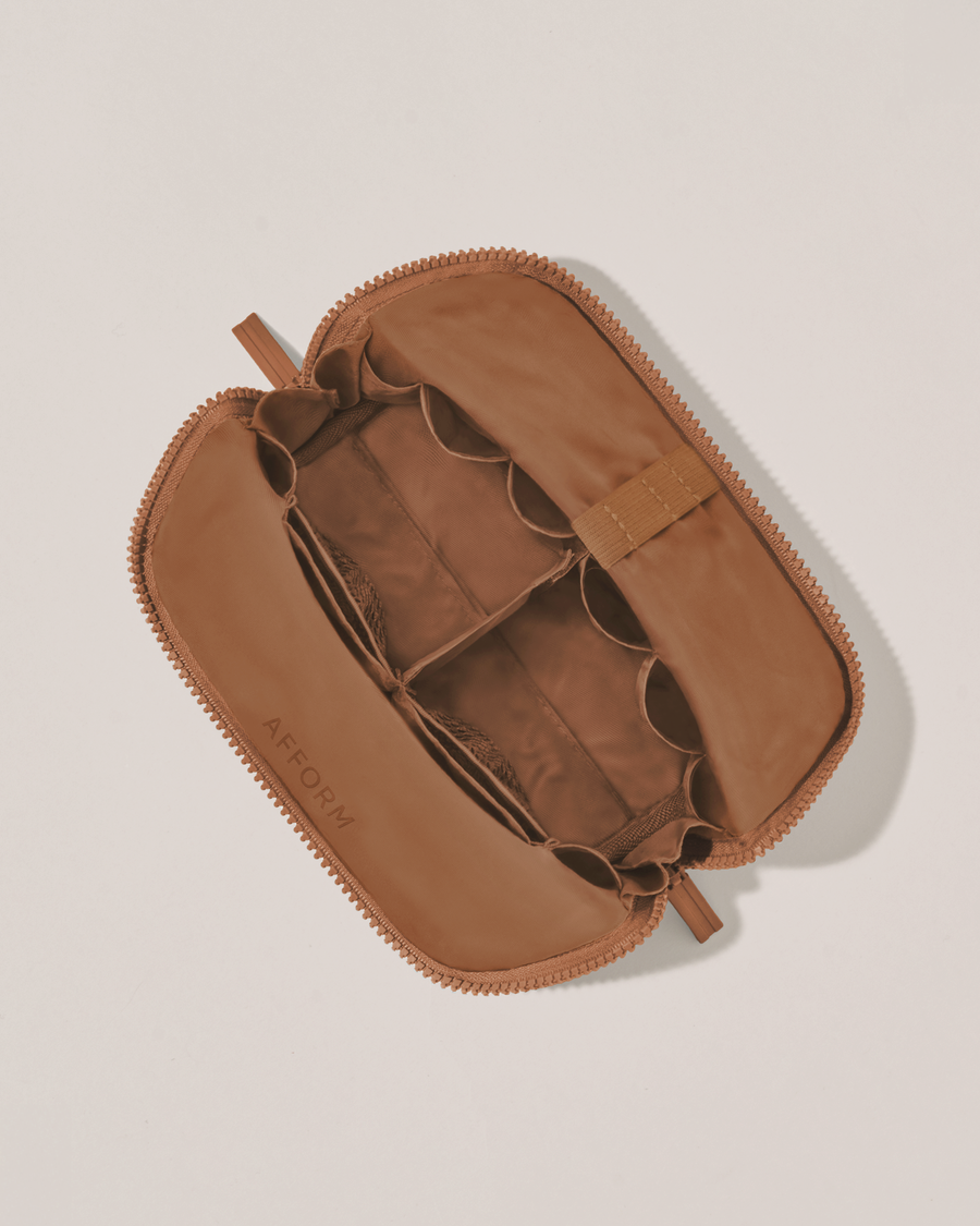 Interior view of Afform Small Vicuna (brown) Traveller makeup bag showing empty pockets, pouches, and elastic holders