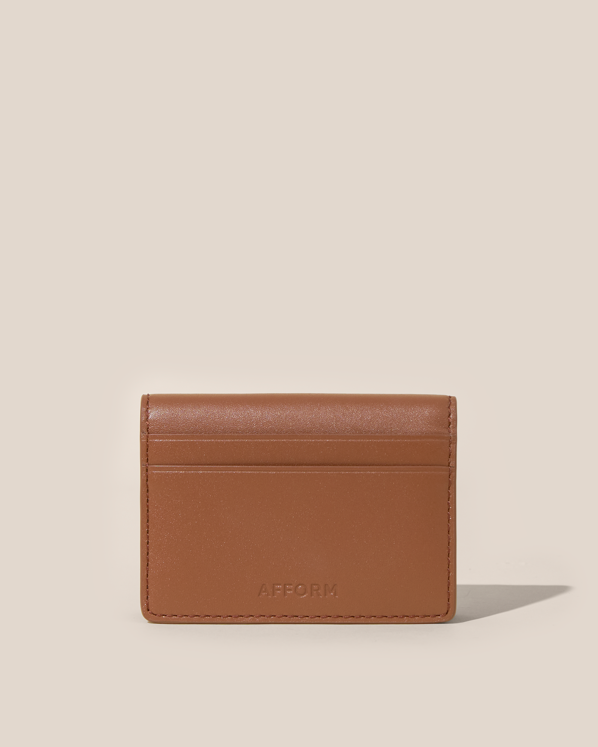 Back of the Afform Vicuna Card Case showing an exterior slip pocket and embossed Afform logo