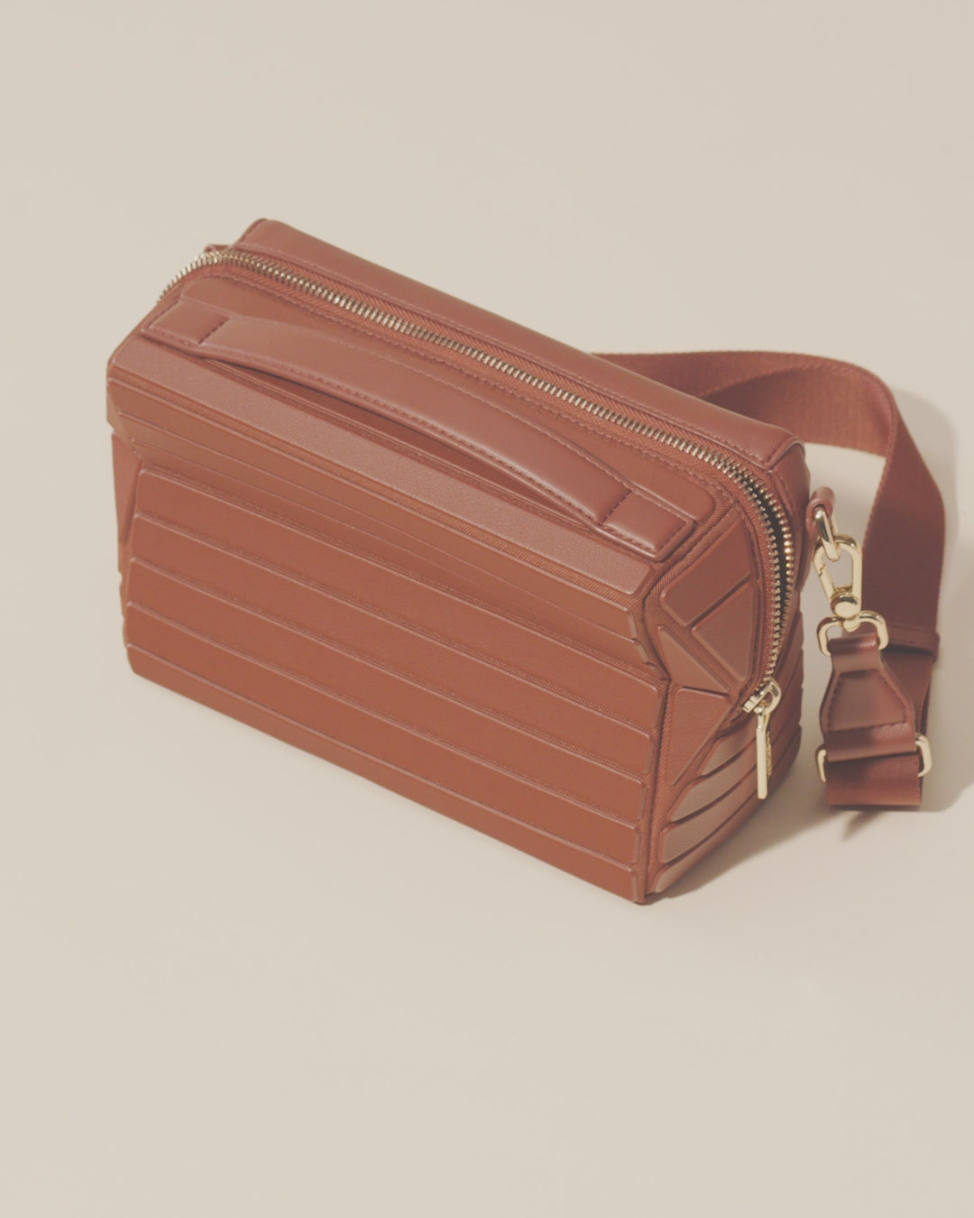 Video of the Afform Vicuna Crossbody bag being unzipped to reveal sunglasses, card holder, and interior pockets