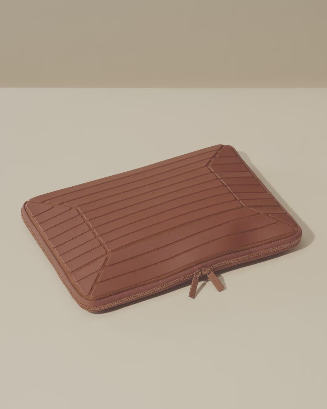 Afform Vicuna (brown) Laptop Case expandable feature video, showing the case filled and closed, then opened and unpacked with a charger, mouse, stylus, and laptop removed one by one